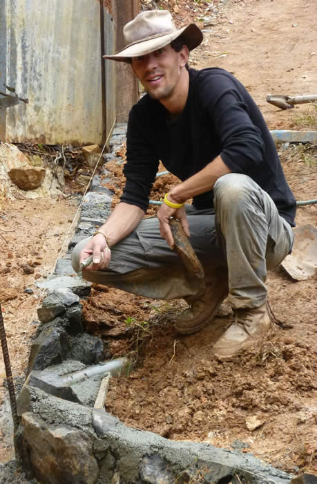 Olaf building  a rock wall drain